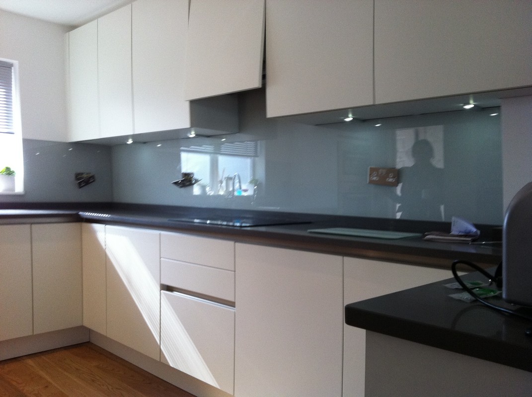 Grey glass kitchen splashback with LED lighting in South Woodford
